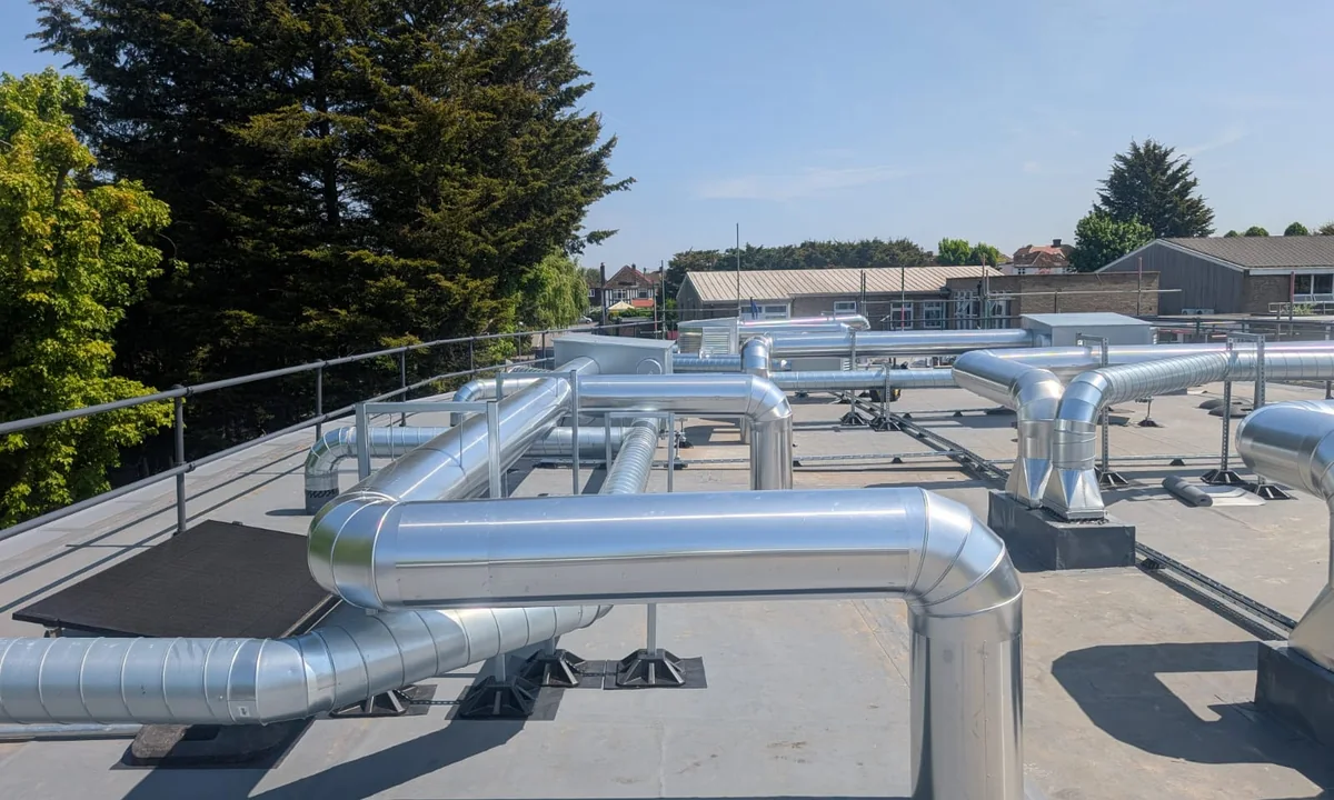 Enviroshield aluminium-clad pipework across a commercial rooftop installation