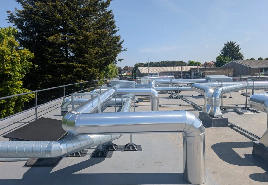Cladded commercial rooftop pipework on a large building