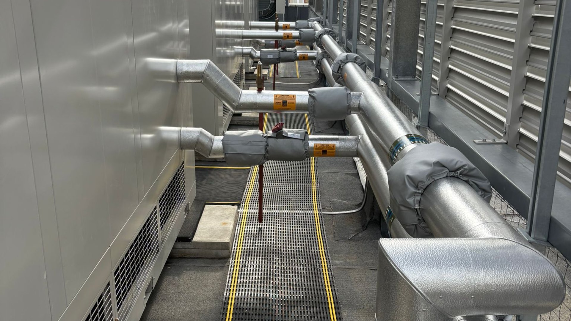 Data centre rooftop pipework serving critical cooling routes