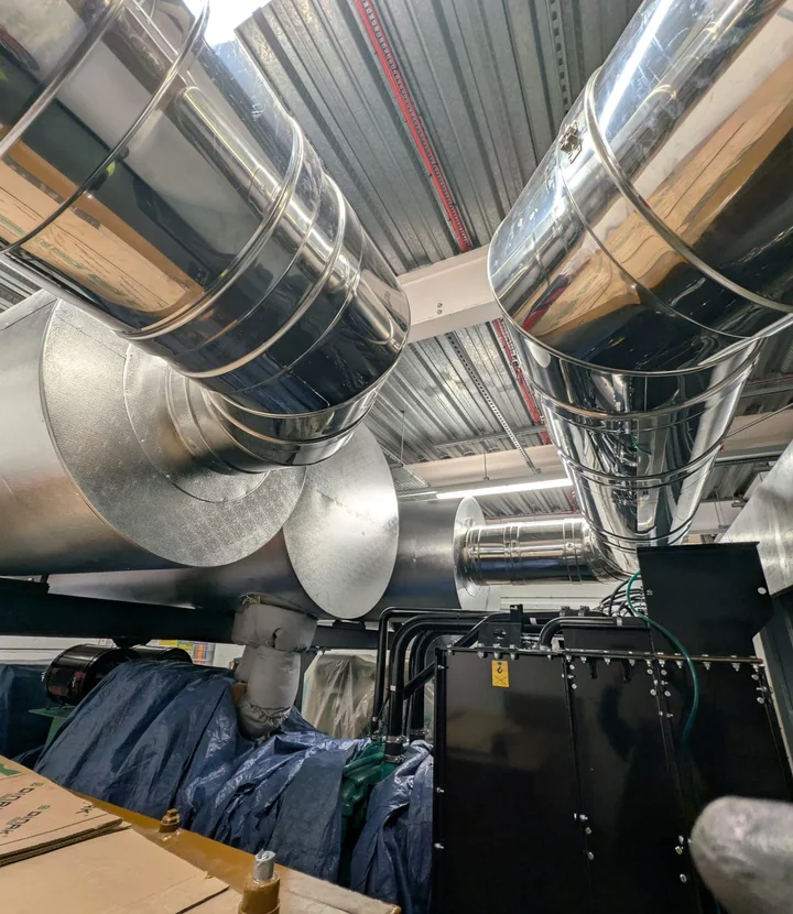 High-rise commercial plant room ductwork with polished metal cladding