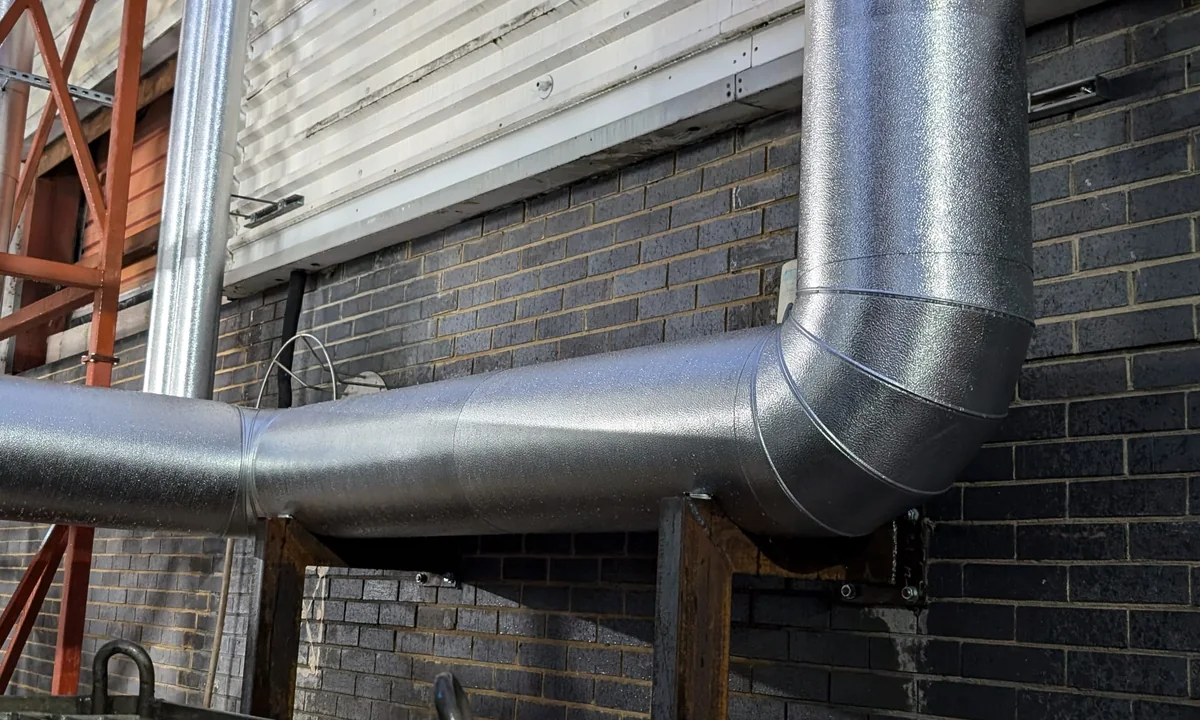 Insulated steam services with metal cladding at a controlled food production site
