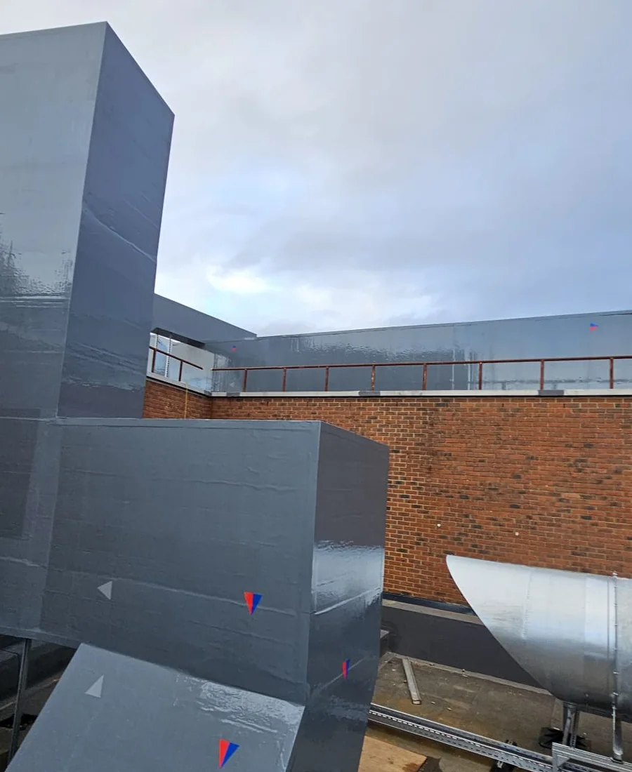External insulated ductwork serving a live retail building