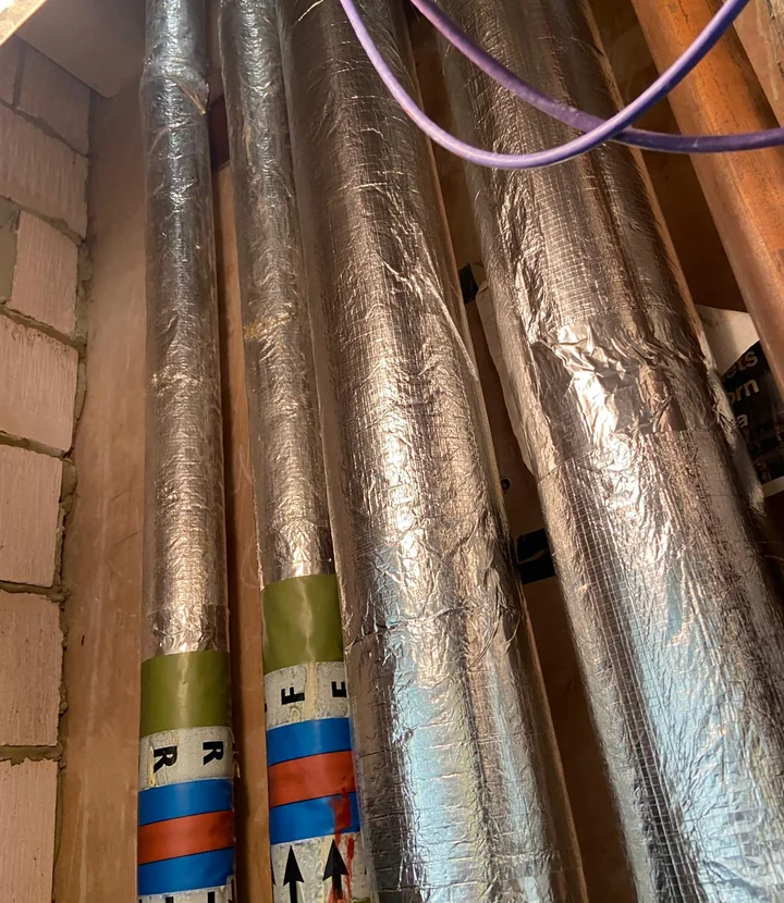 Insulated pipework detail with service identification bands