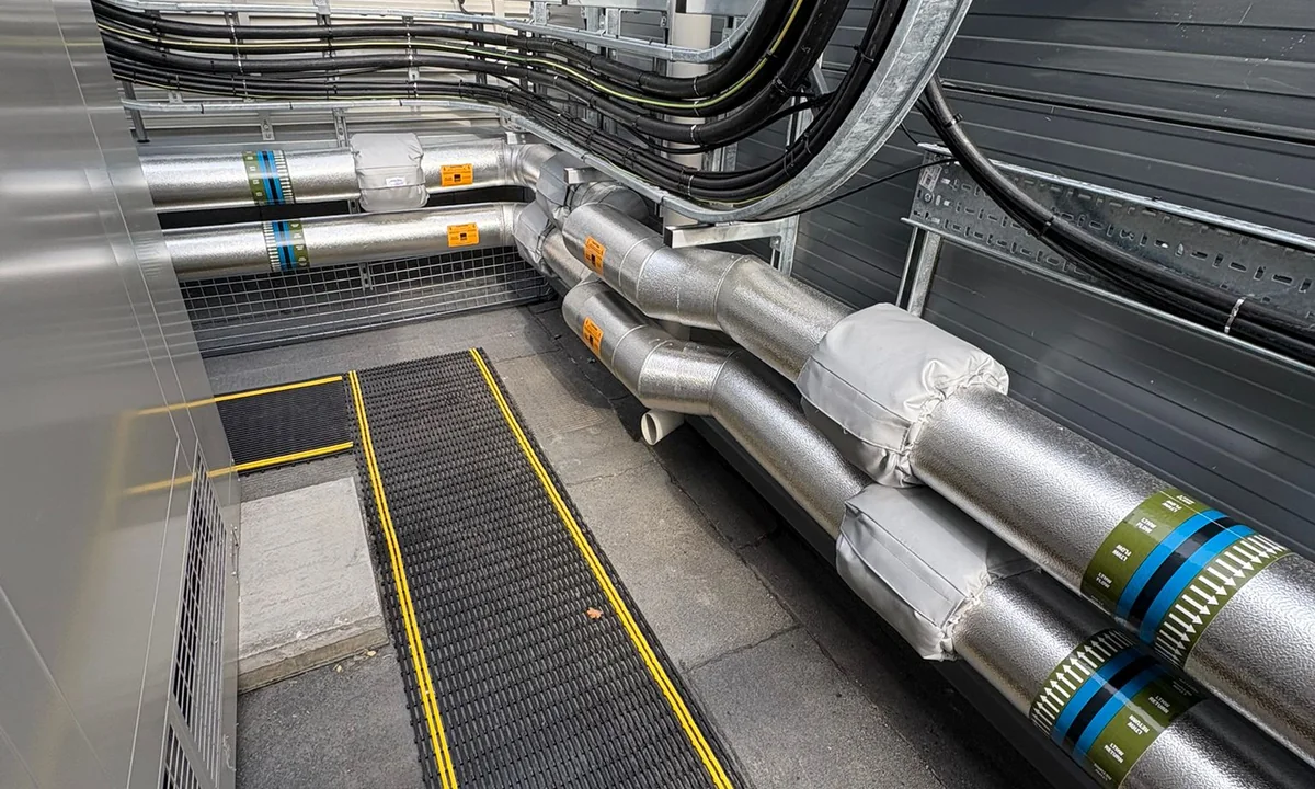 Completed trace-heated rooftop pipework with phenolic insulation, stucco cladding and removable jackets