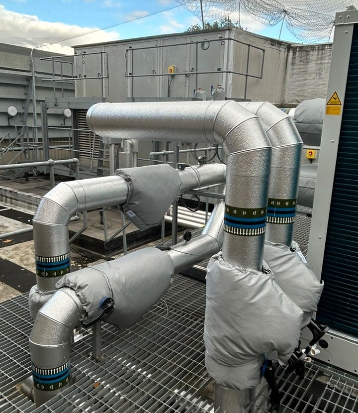 Weatherproof external insulation detail around rooftop service runs
