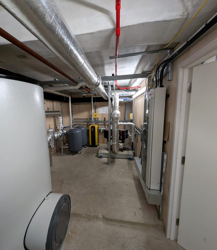 Plant room insulation support for exposed commercial services