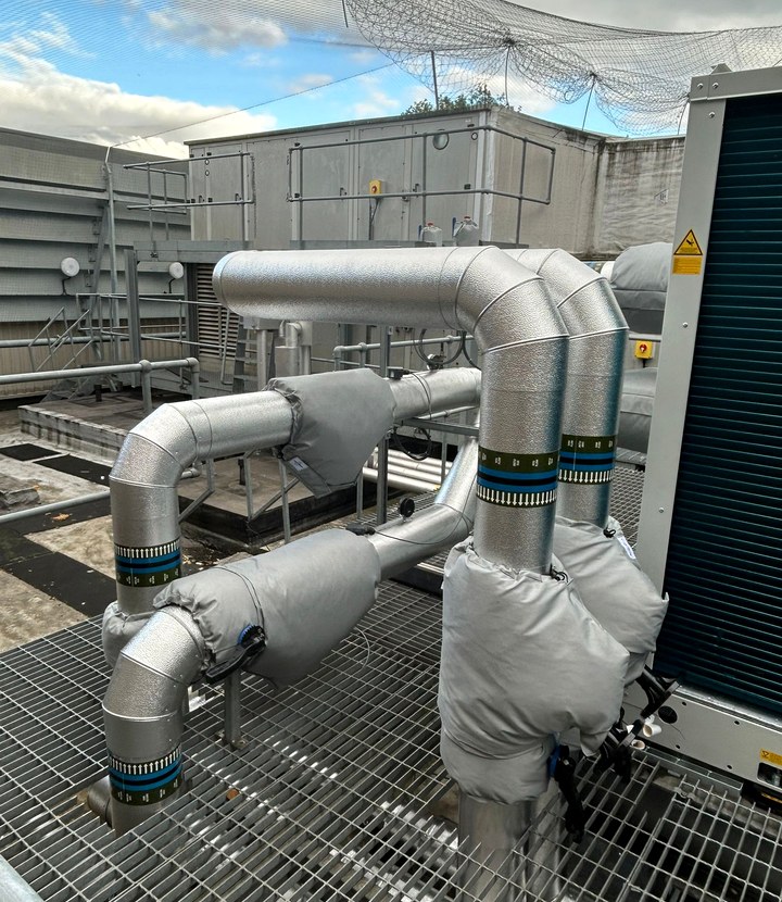 Weatherproof external insulation detail around rooftop service runs
